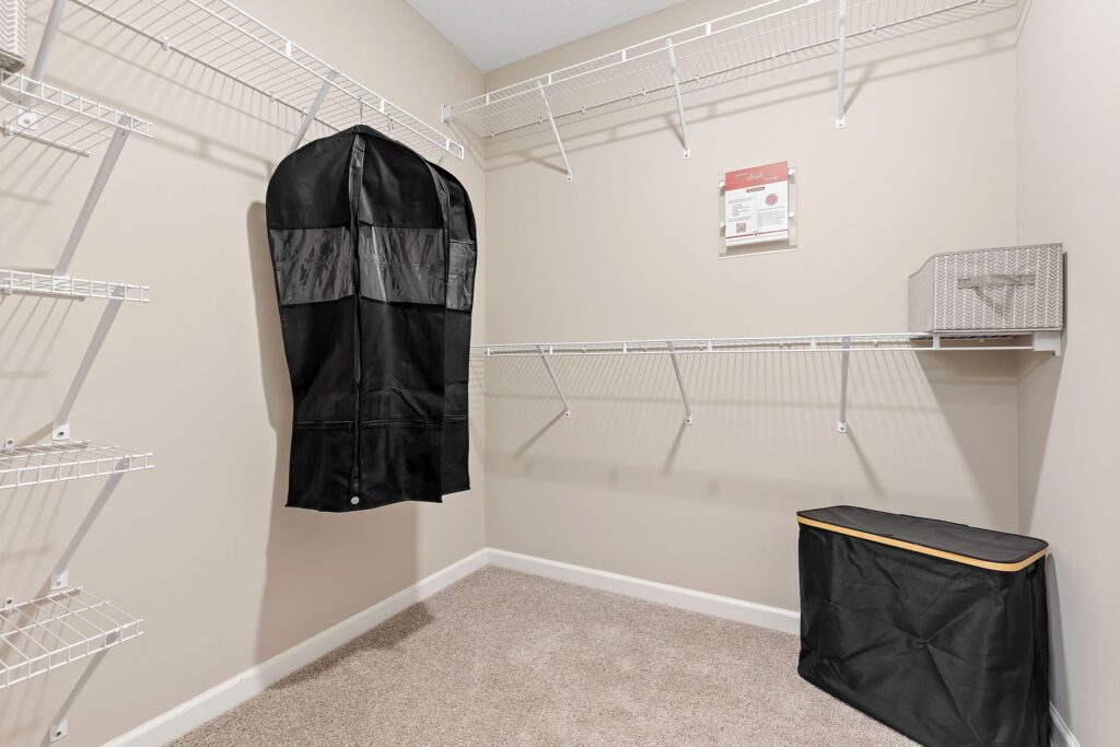 A black coat in a closet.