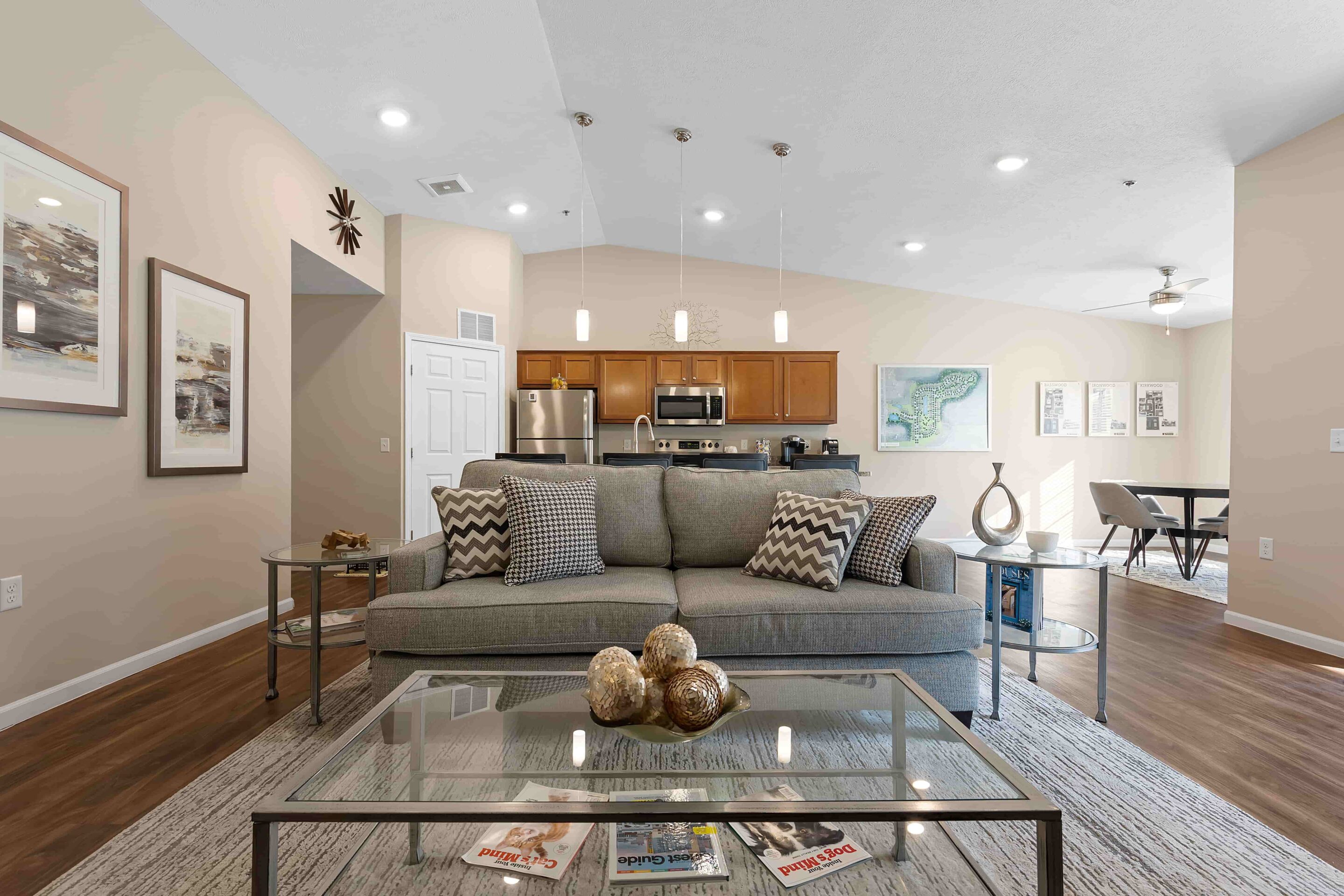 A living room with a couch and a glass coffee table.
